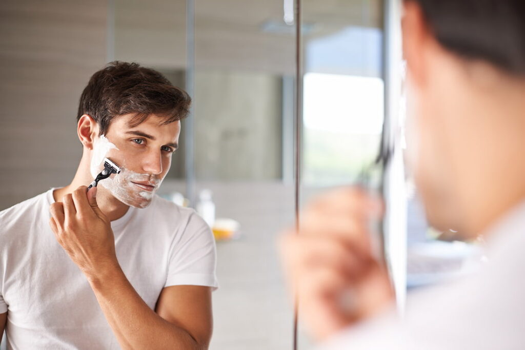 man shaving beard